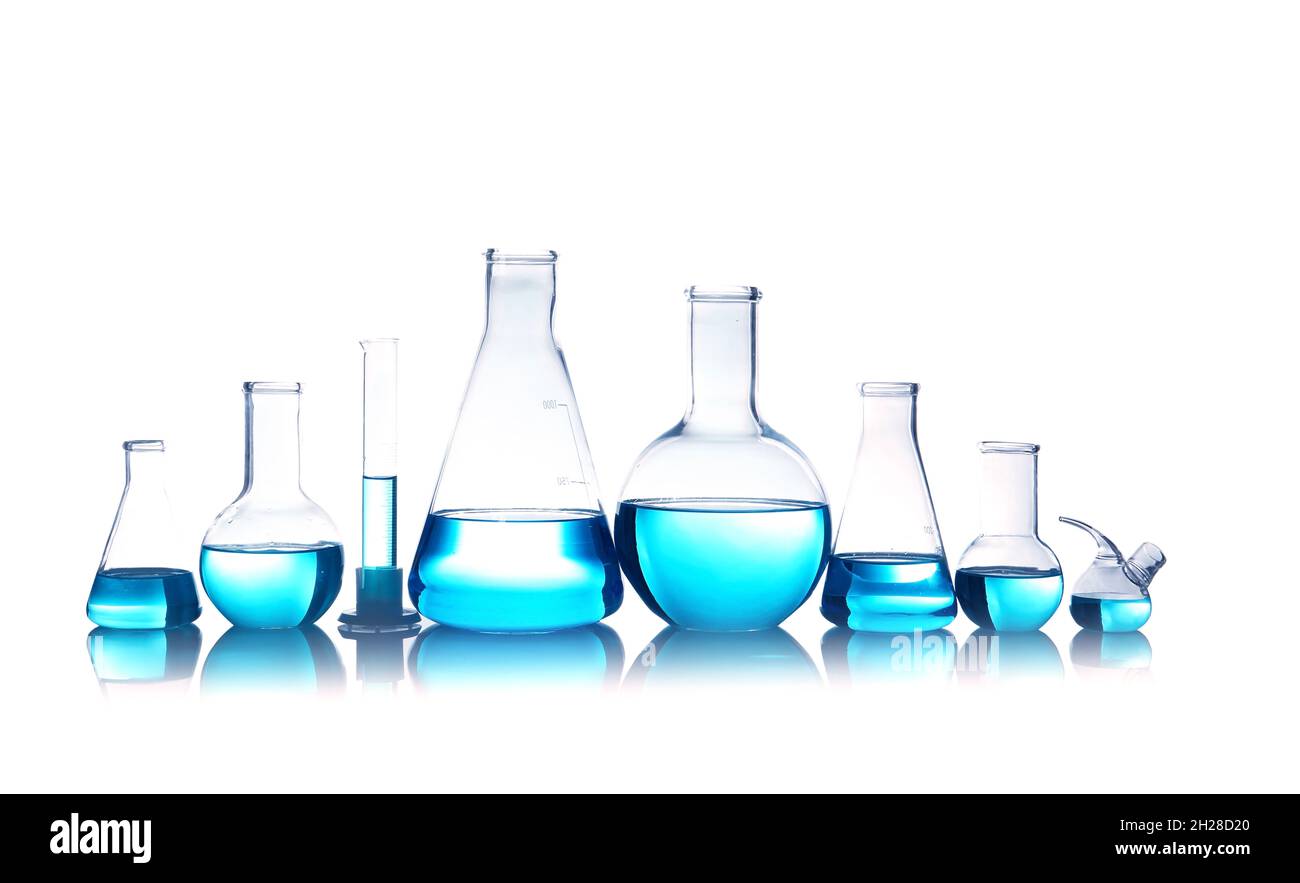 Laboratory glassware for chemical analysis with blue liquid on table ...