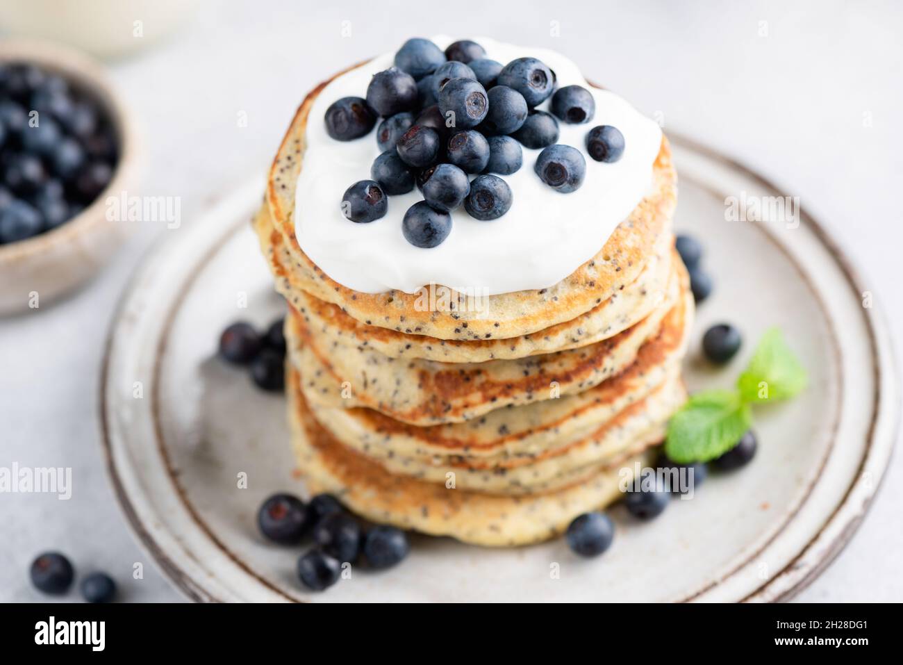 Chia seed pancakes with yogurt and blueberries on plate closeup view Stock Photo