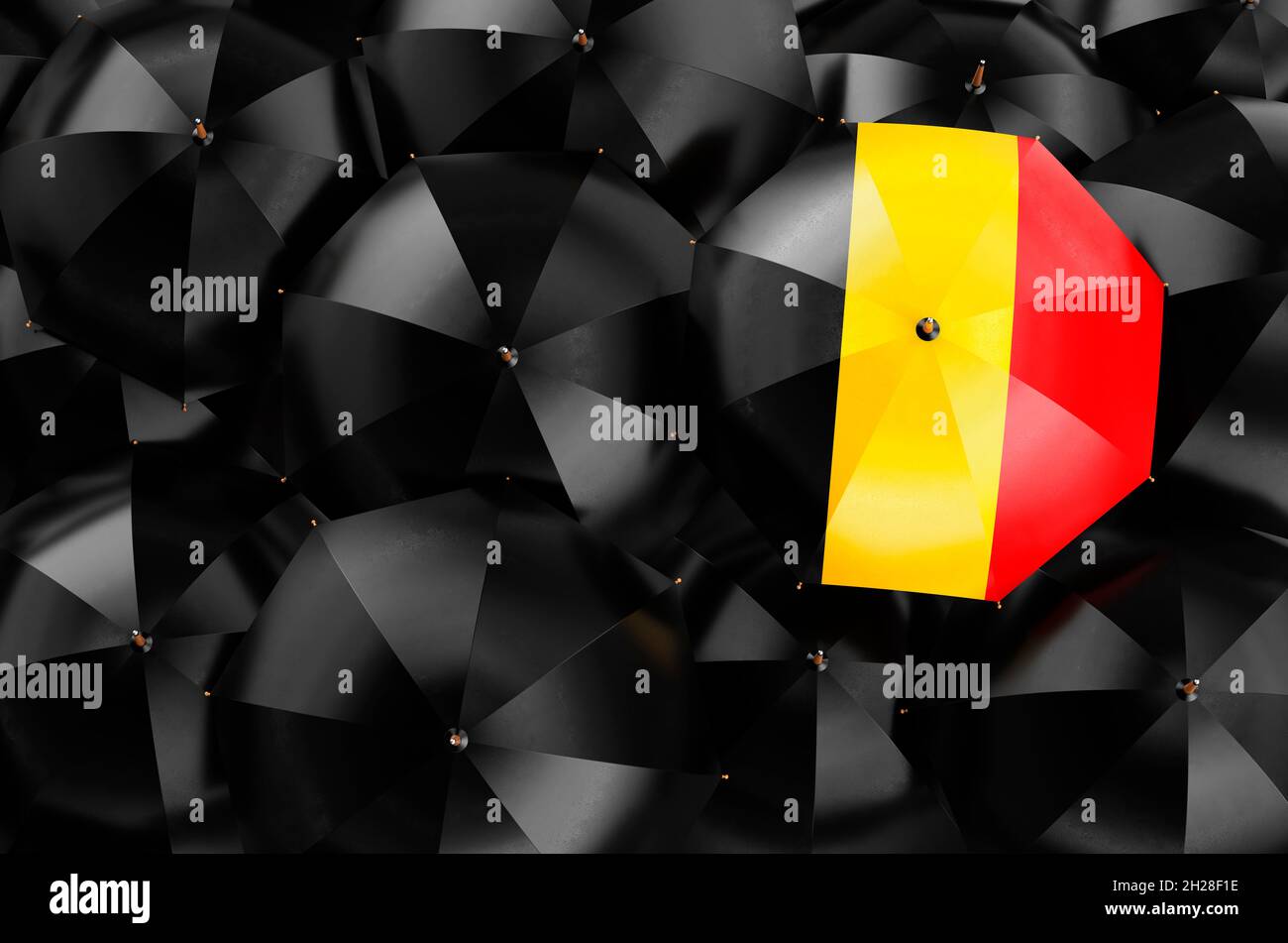 Umbrella with Belgian flag among black umbrellas, top view. 3D rendering Stock Photo