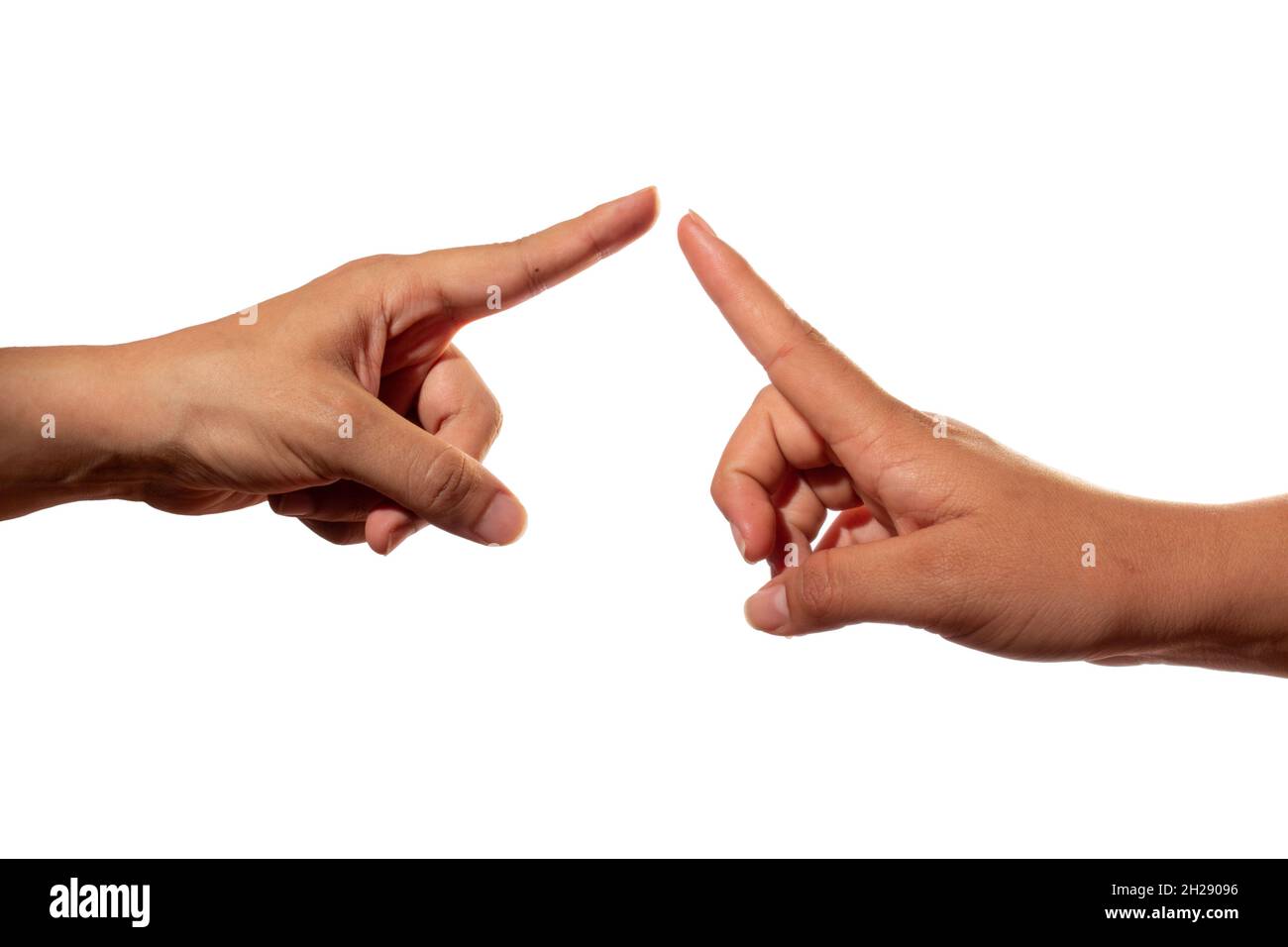 Two hands stretching out their index finger to touch each other. Two fingers about to touch. Union of fingers, isolated on white background. Stock Photo