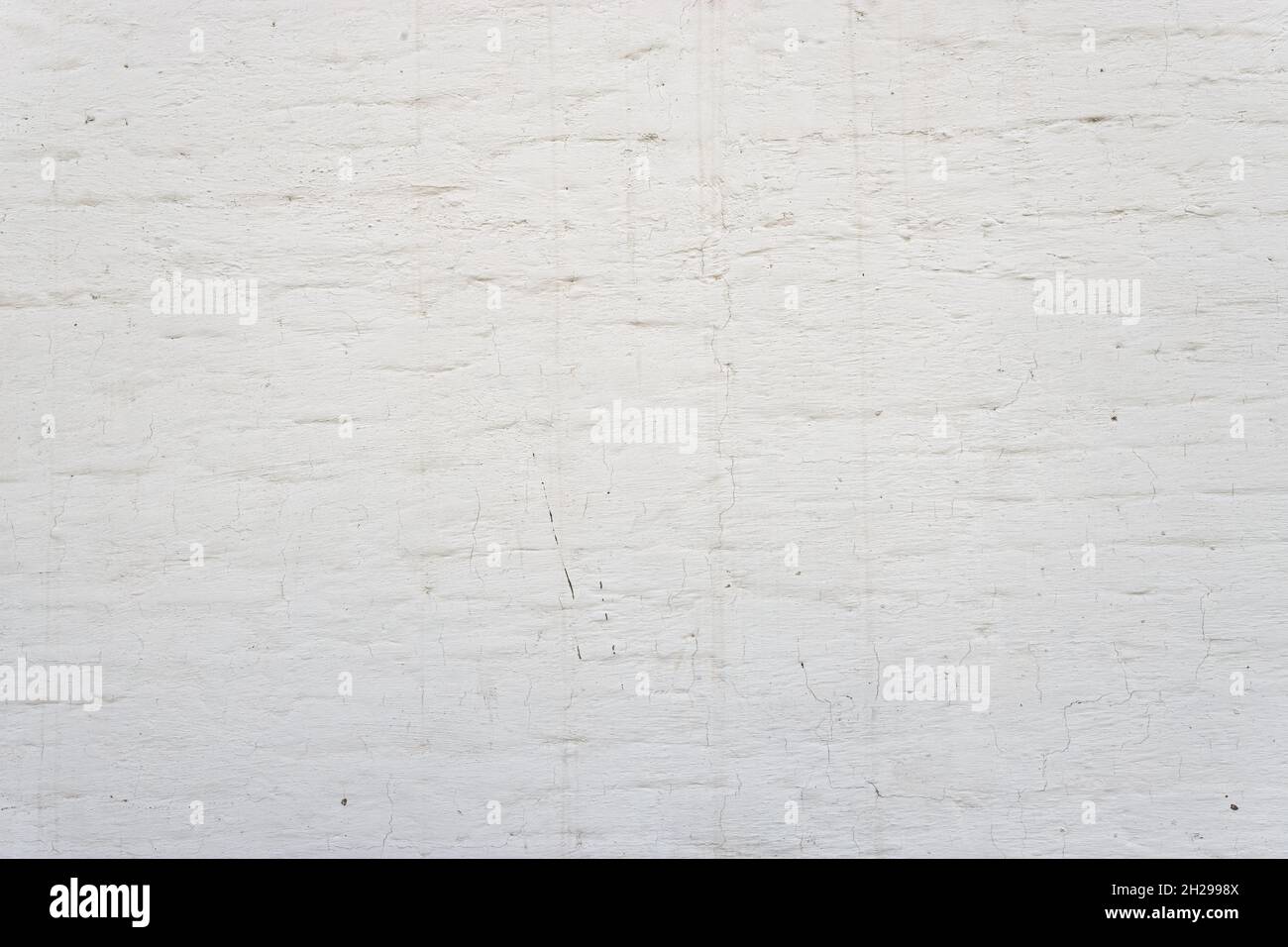 White brick wall background. Simple grungy white brick wall as seamless pattern texture background. Stock Photo