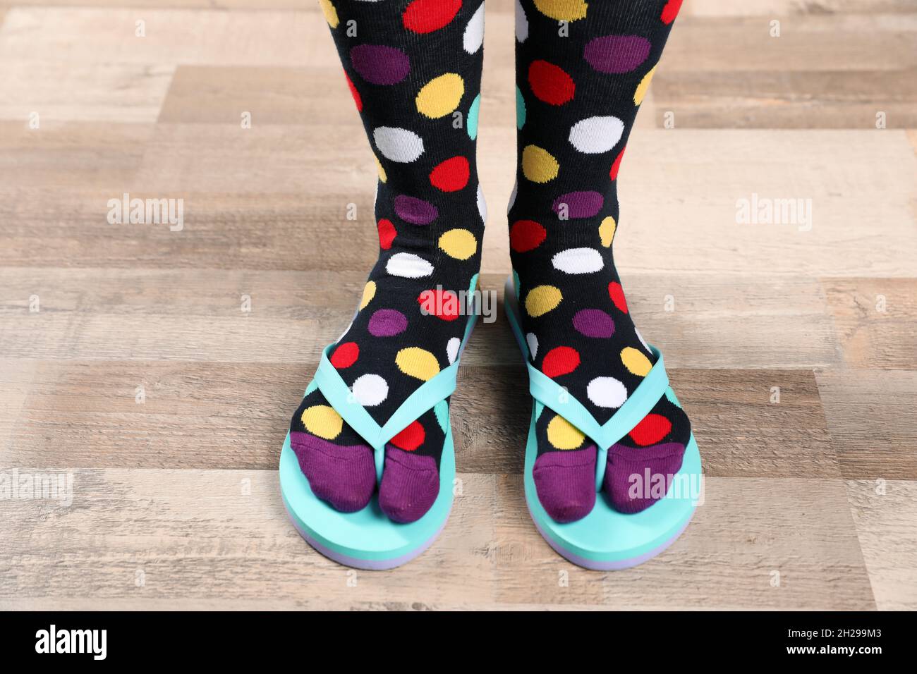 Woman wearing bright socks with flip flops standing on floor Stock Photo Alamy