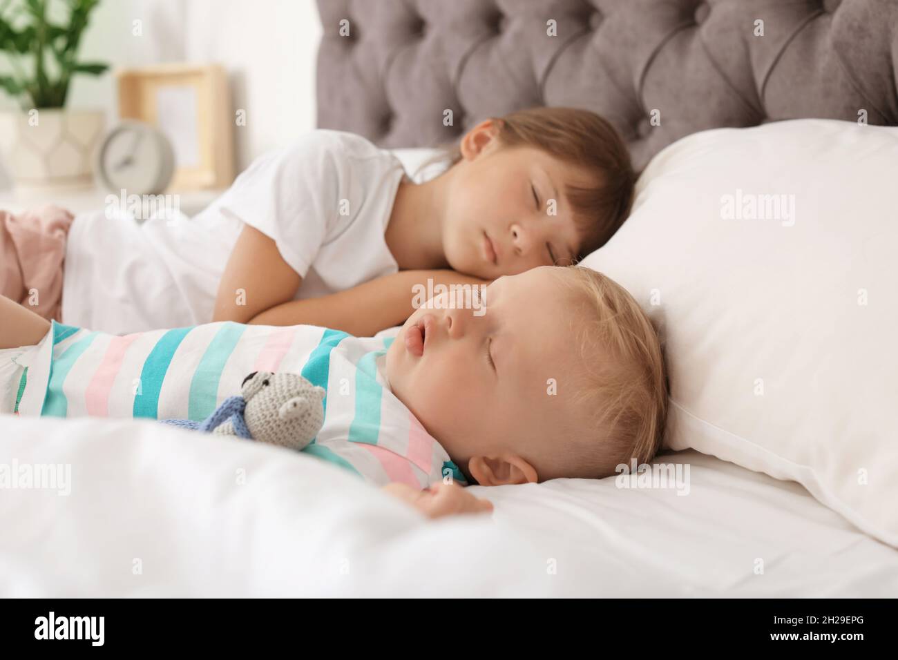 Little children sleeping in bed at home Stock Photo Alamy