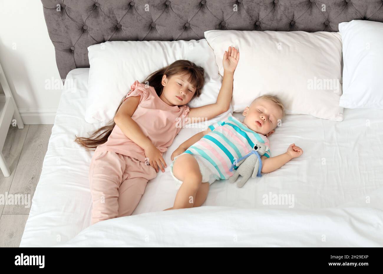 Little children sleeping in bed at home Stock Photo Alamy