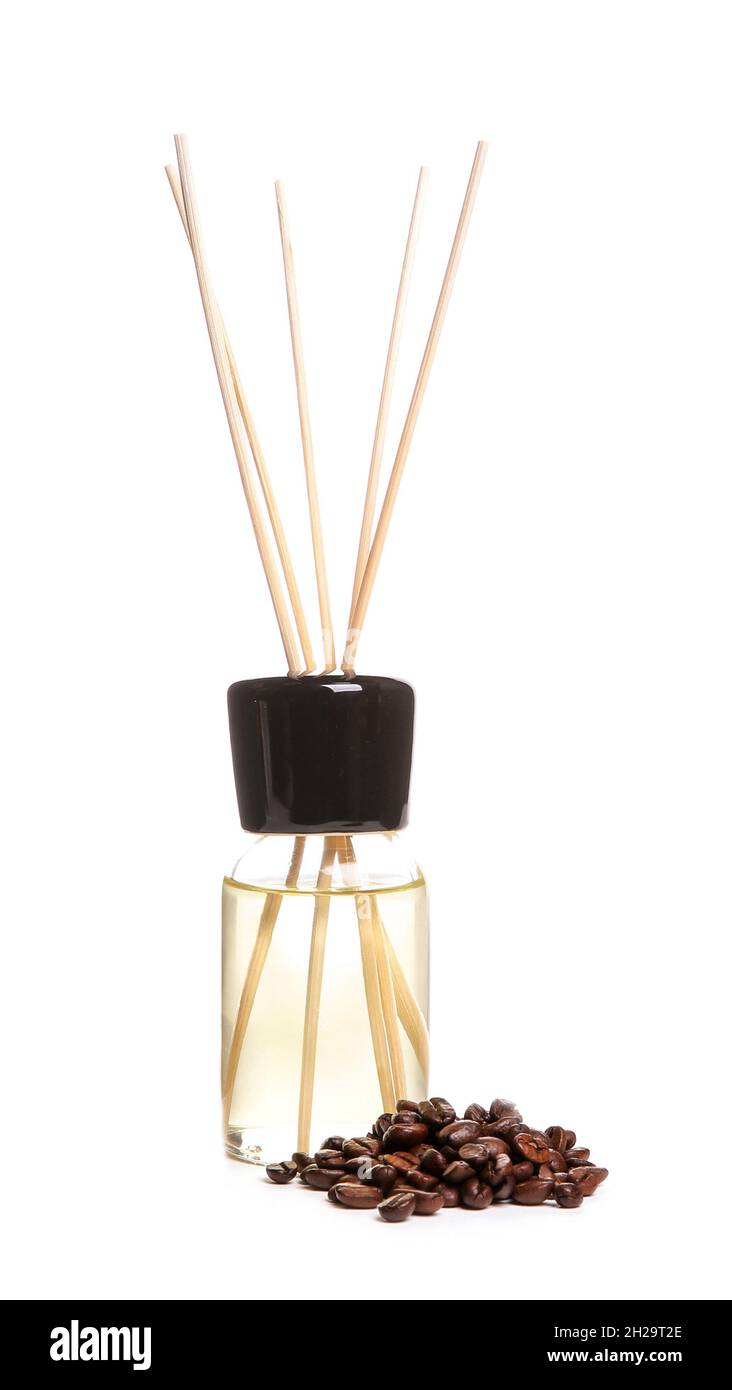 Aromatic reed air freshener and coffee beans on white background Stock