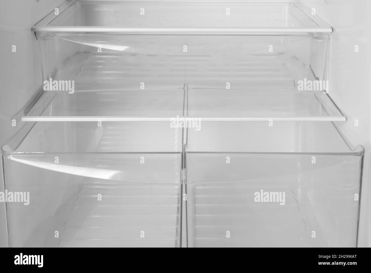 Modern open refrigerator with empty shelves, closeup Stock Photo