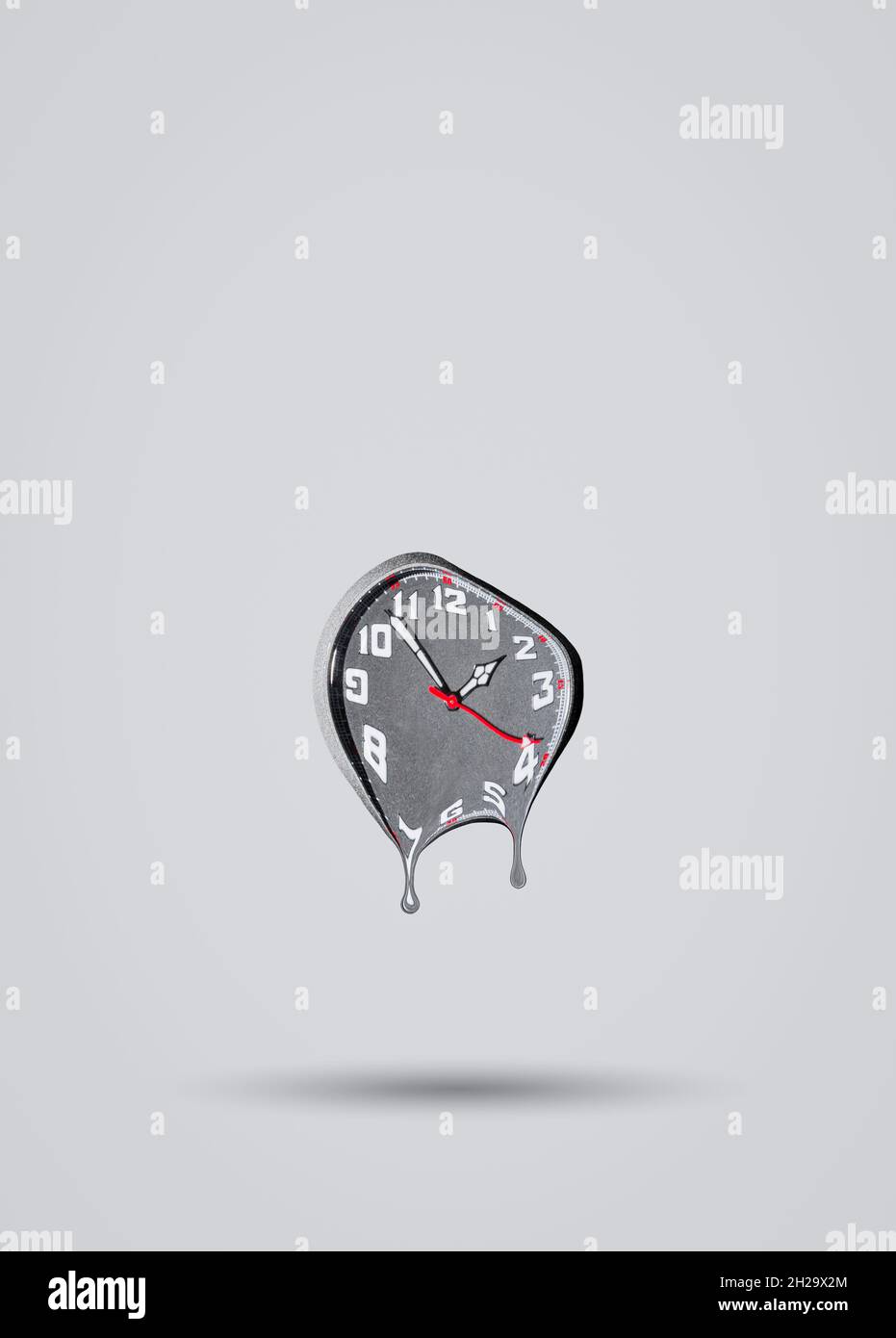 Melting clock on grey background. Time passing by idea. Minimal abstract life or business concept. With copy space. Stock Photo