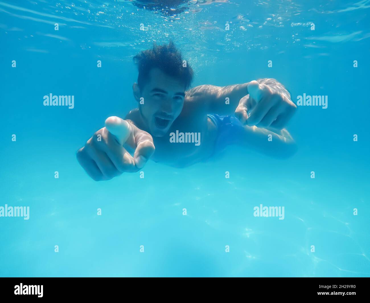 Handsome young man swimming in pool, underwater view Stock Photo - Alamy
