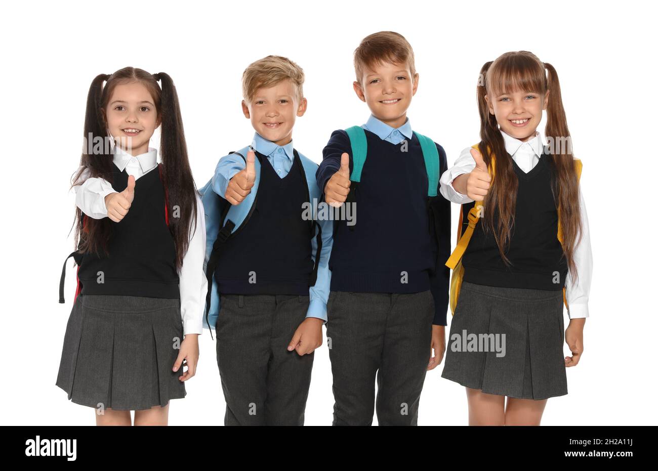 Little children in stylish school uniform on white background Stock