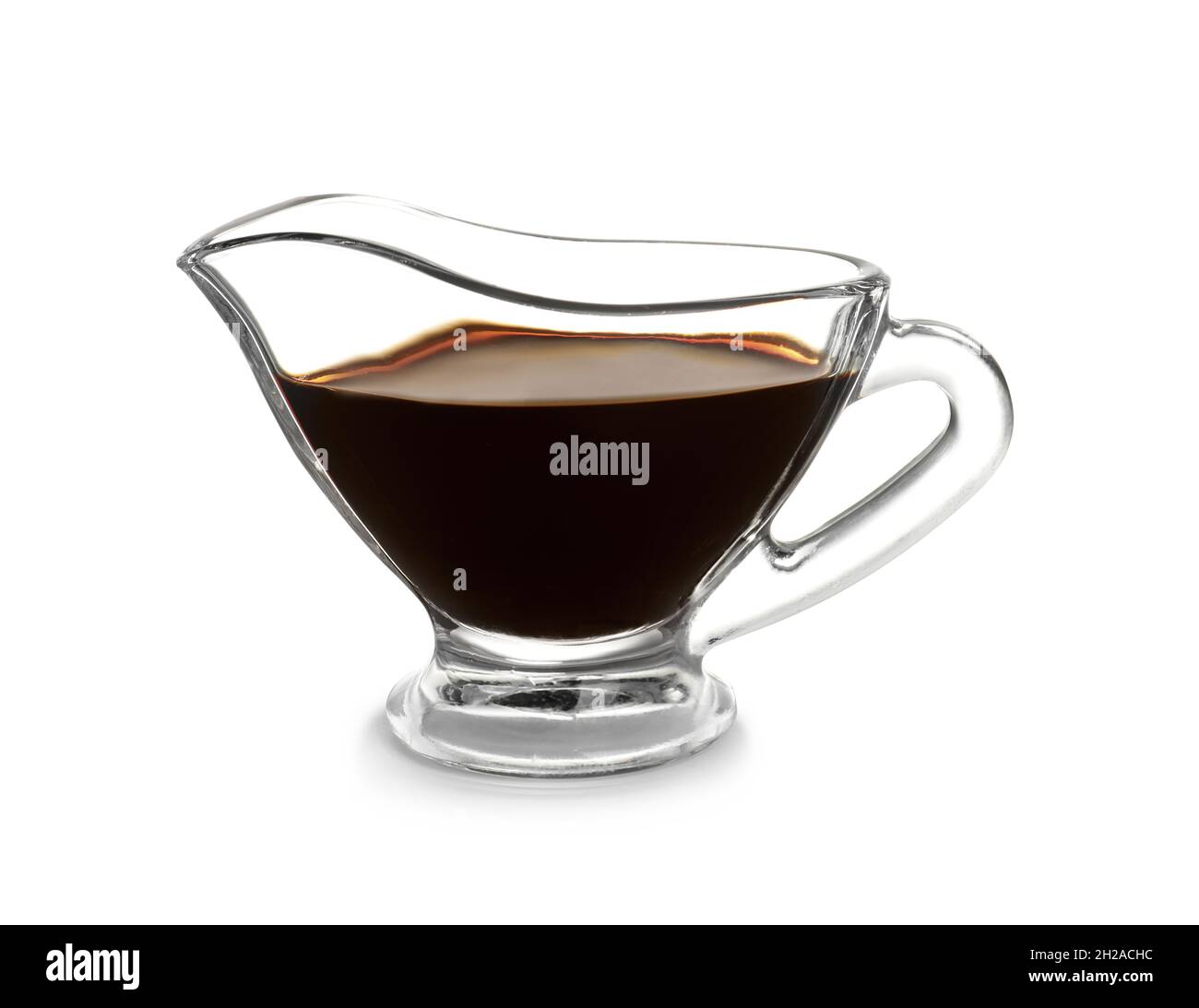Glass gravy boat with balsamic vinegar on white background Stock Photo