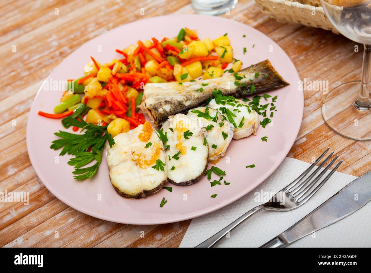 Oven baked hake with vegetable garnish Stock Photo