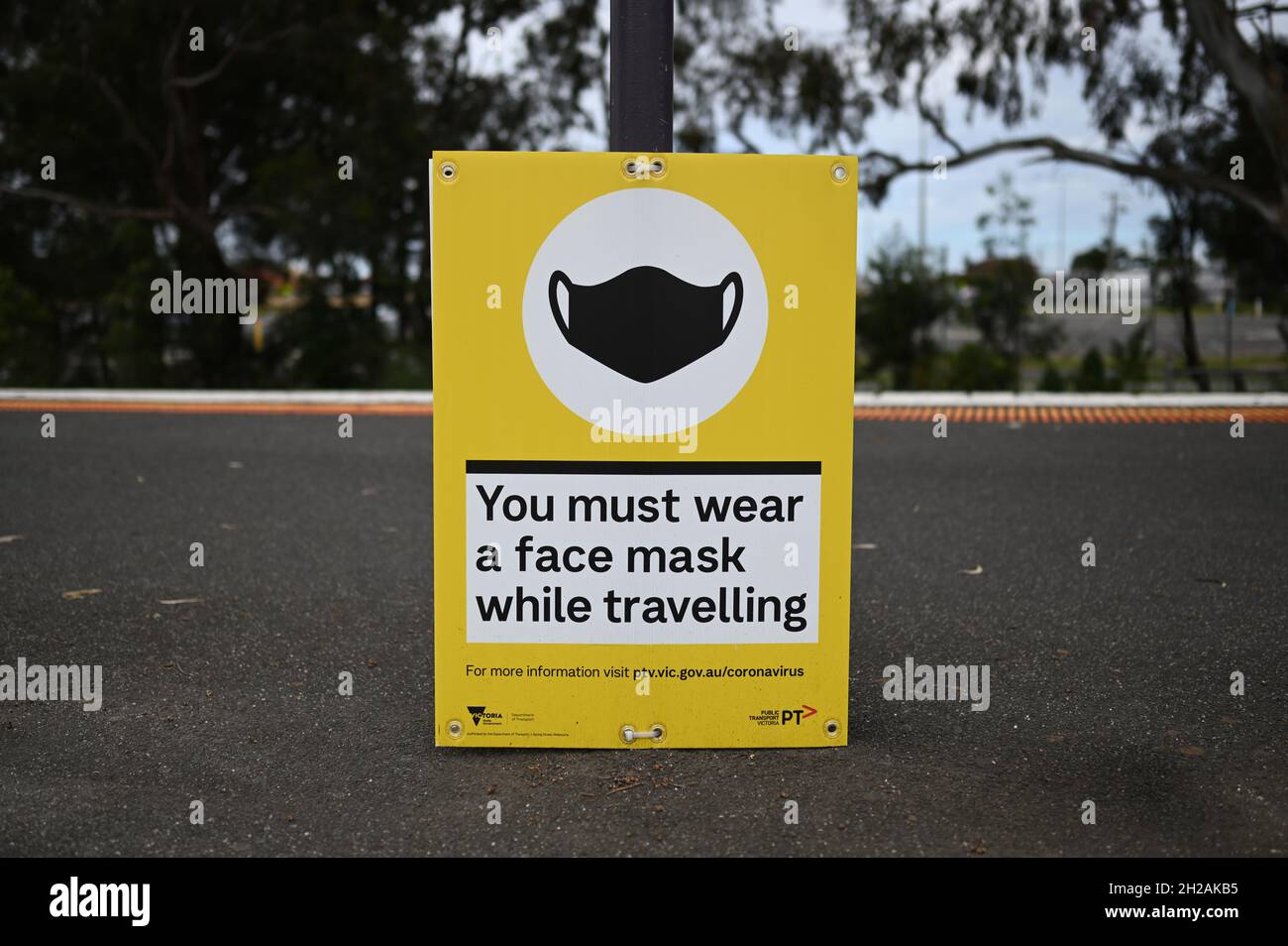 A sign at Sandown Park train station informing passengers that they are expected to wear a face mask while travelling Stock Photo