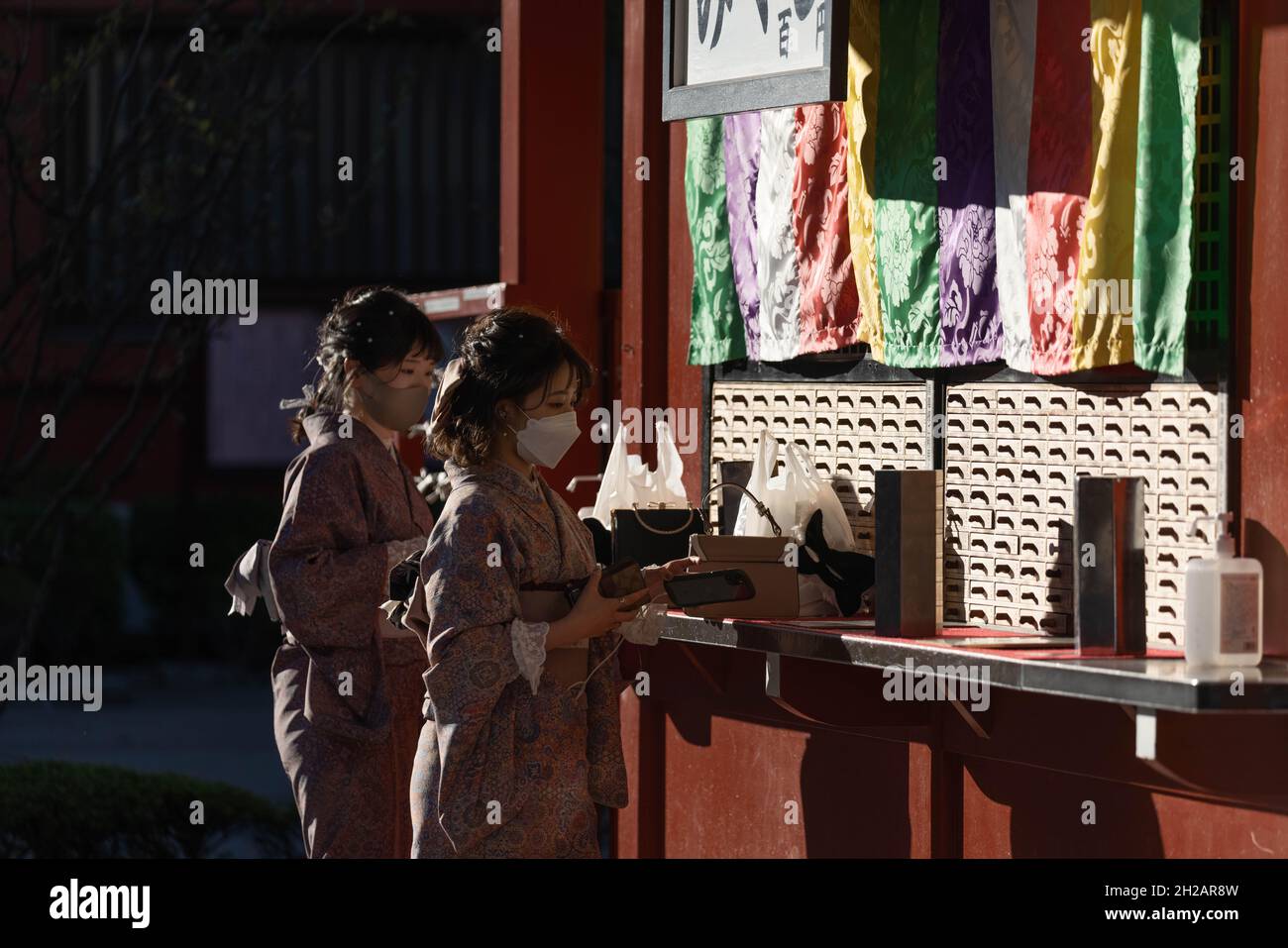 Tokyo, Japan. 20th Oct, 2021. Women dressed in Kimono seen buying "Mikuji" (fortune slips) at the Senso-Ji temple in Asakusa, Tokyo.After the Covid-19 pandemic related State of emergency was lifted on September 30, visitors are returning to Tokyo's tourist hot spot in Asakusa. (Photo by Stanislav Kogiku/SOPA Images/Sipa USA) Credit: Sipa USA/Alamy Live News Stock Photo