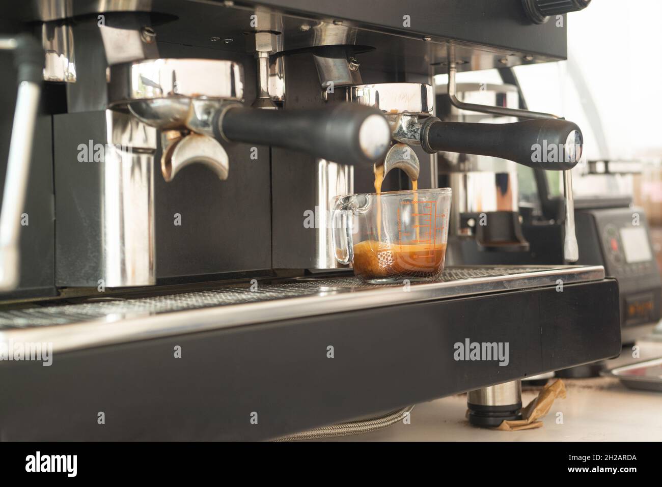 https://c8.alamy.com/comp/2H2ARDA/large-coffee-machine-and-black-mug-while-making-coffee-small-business-concept-2H2ARDA.jpg