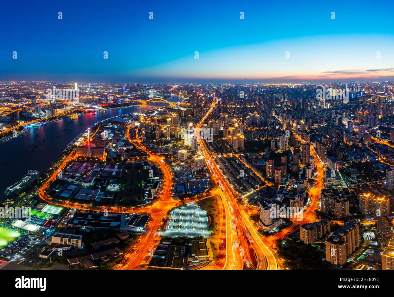 Aerial view of modern city skyline and buildings at night in Shanghai ...
