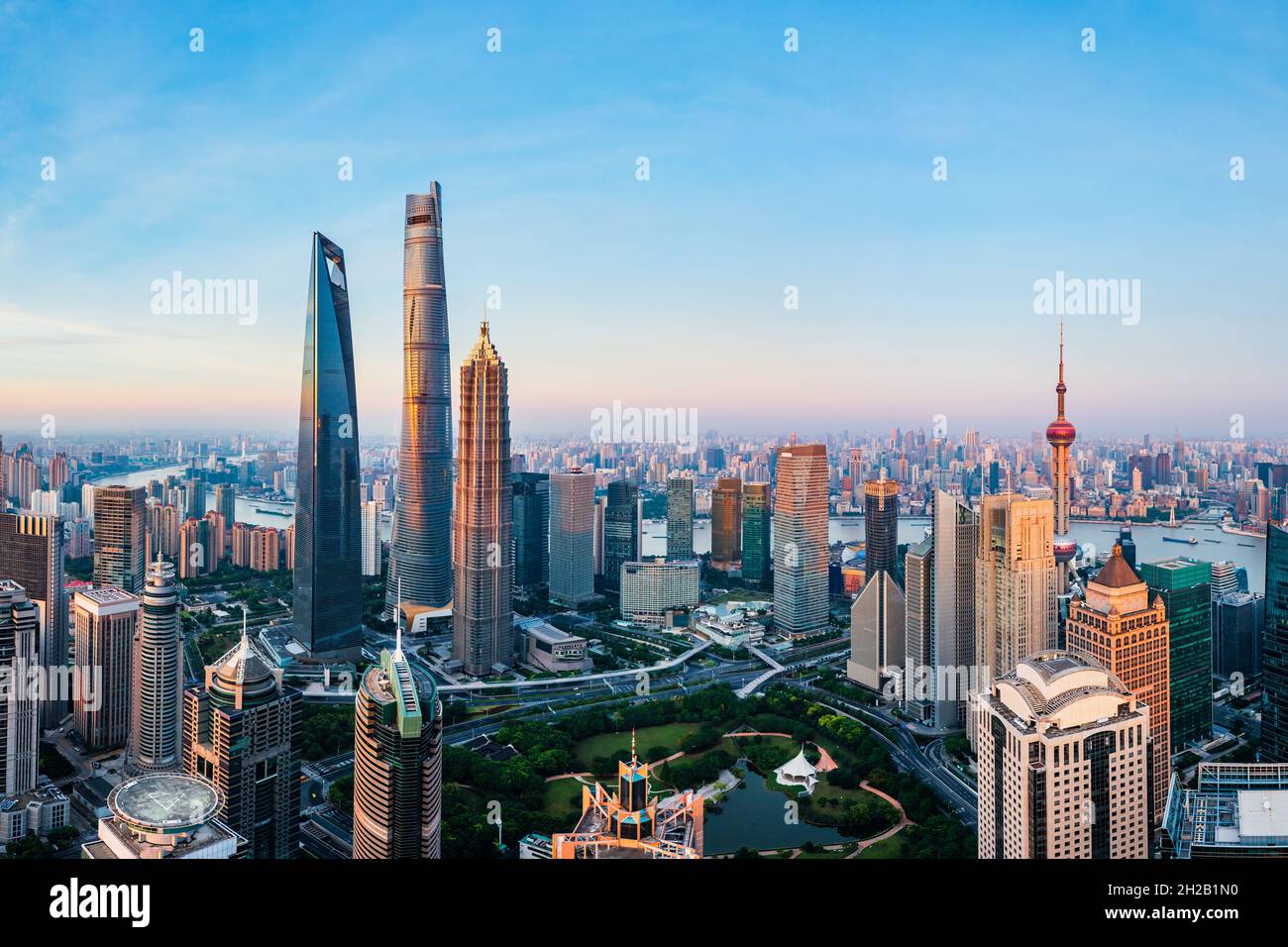 Aerial view of modern city skyline and buildings at sunrise in Shanghai ...