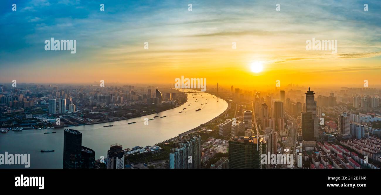 Aerial view of modern city skyline and buildings at sunrise in Shanghai ...
