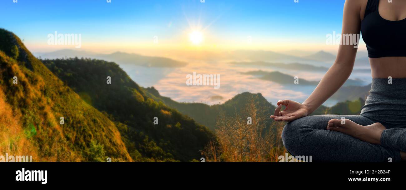 Young woman practicing yoga in the nature.female happiness. Landscape background Stock Photo