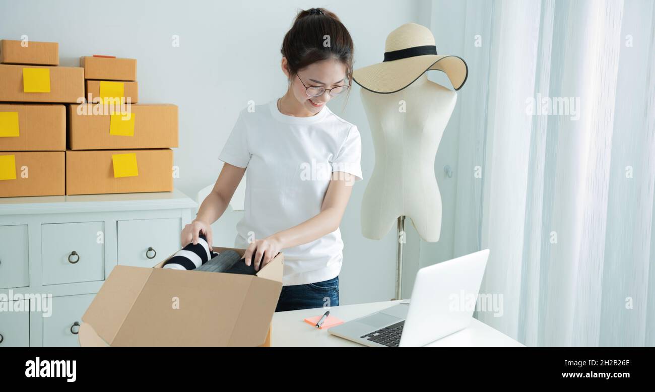 Young asian girl is freelancer with her private business at home office. Fashion designer stylish showroom concept Stock Photo