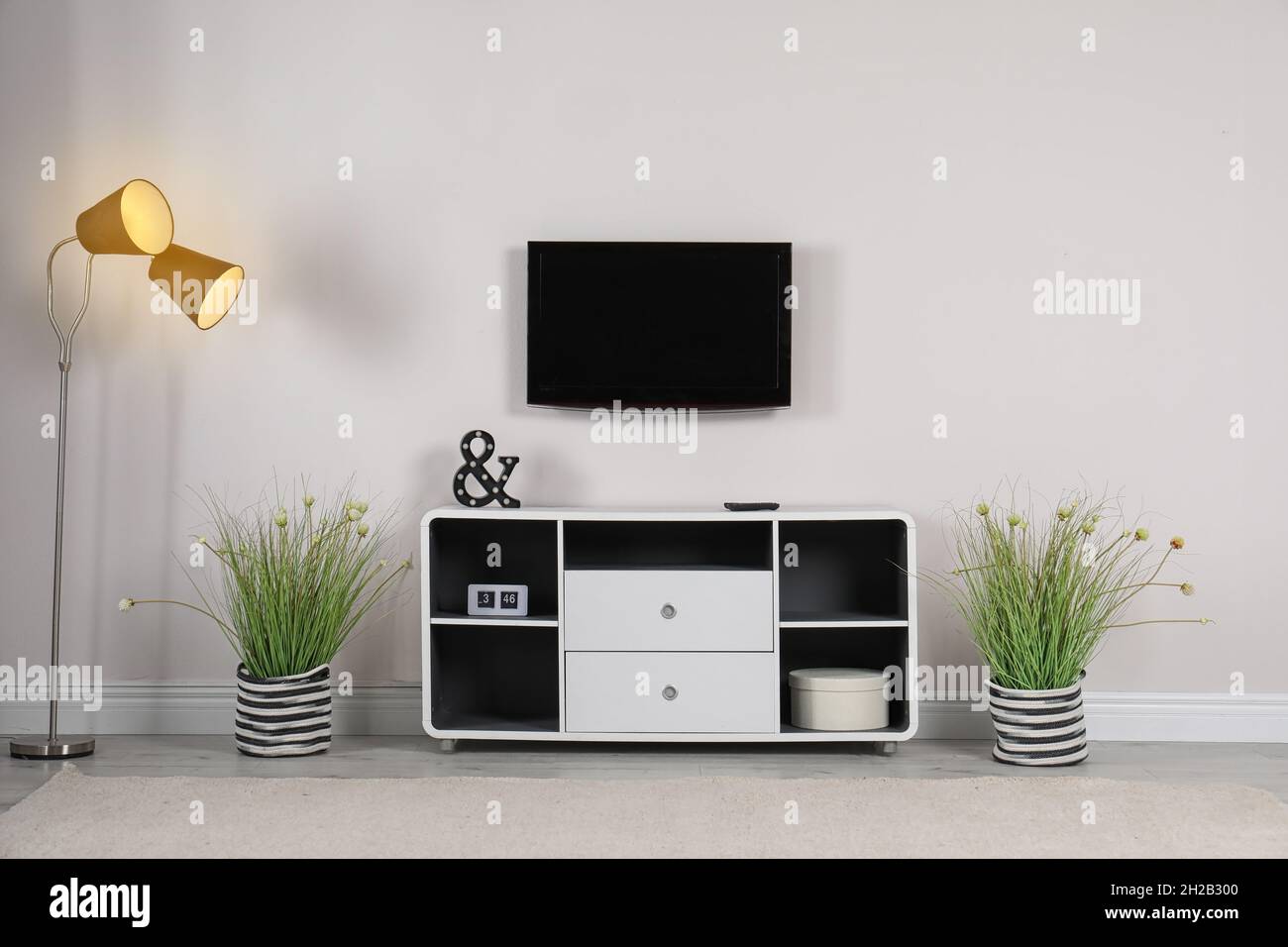 Living room interior with plasma TV on light wall Stock Photo - Alamy