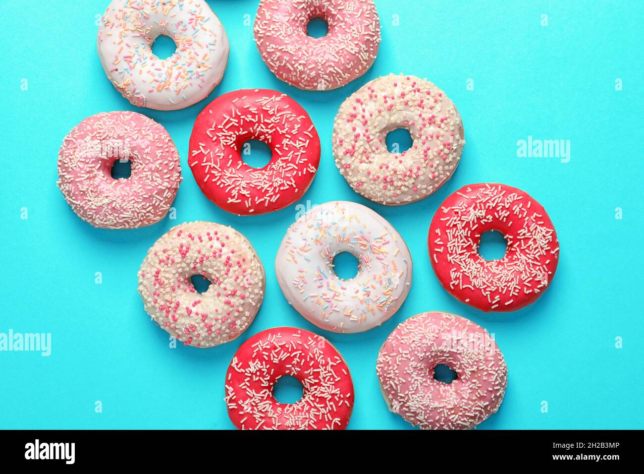 Delicious glazed doughnuts on color background, top view Stock Photo ...