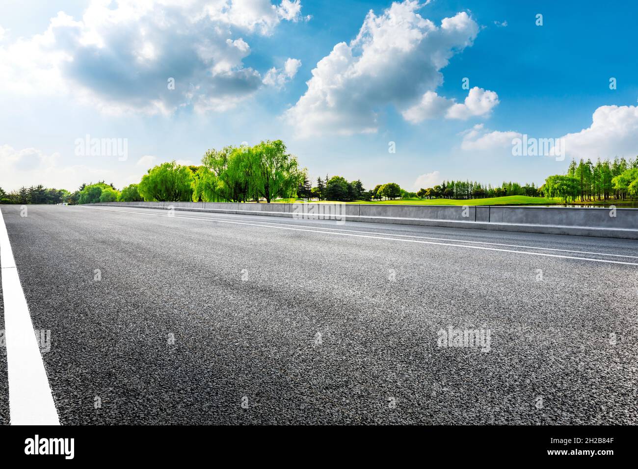 Empty asphalt road and green trees in spring season Stock Photo - Alamy