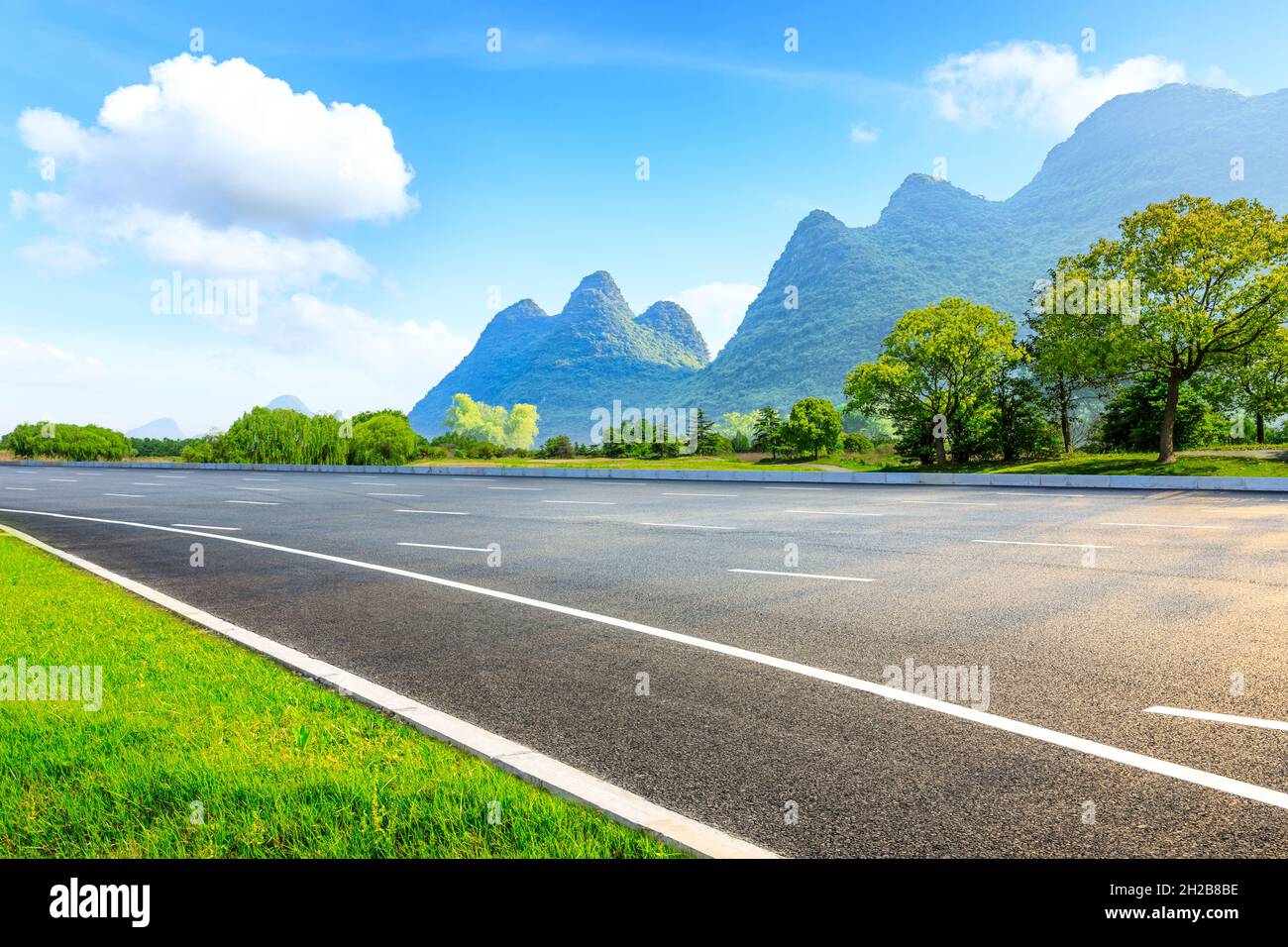 Asphalt road and green mountain natural landscape Stock Photo - Alamy