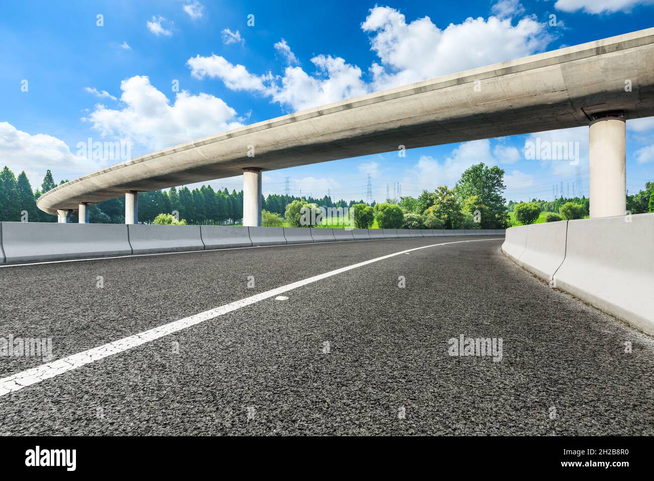 Asphalt road and green forest in spring season Stock Photo - Alamy