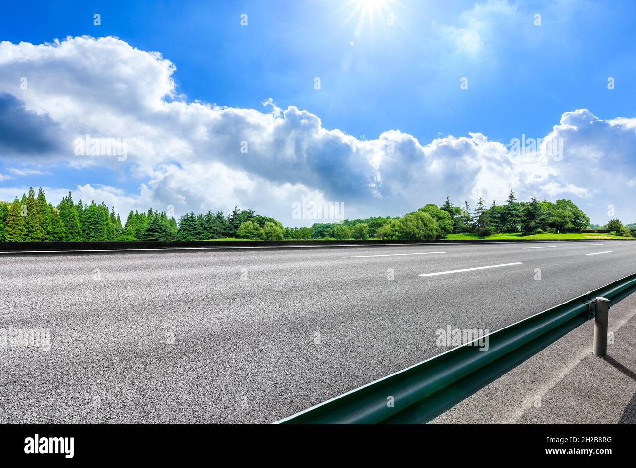 Asphalt road and green trees in spring season Stock Photo - Alamy