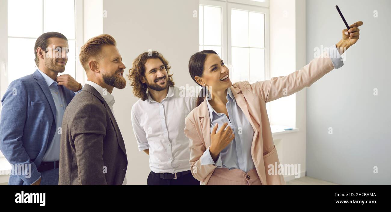 Smiling diverse employees make selfie on cellphone Stock Photo