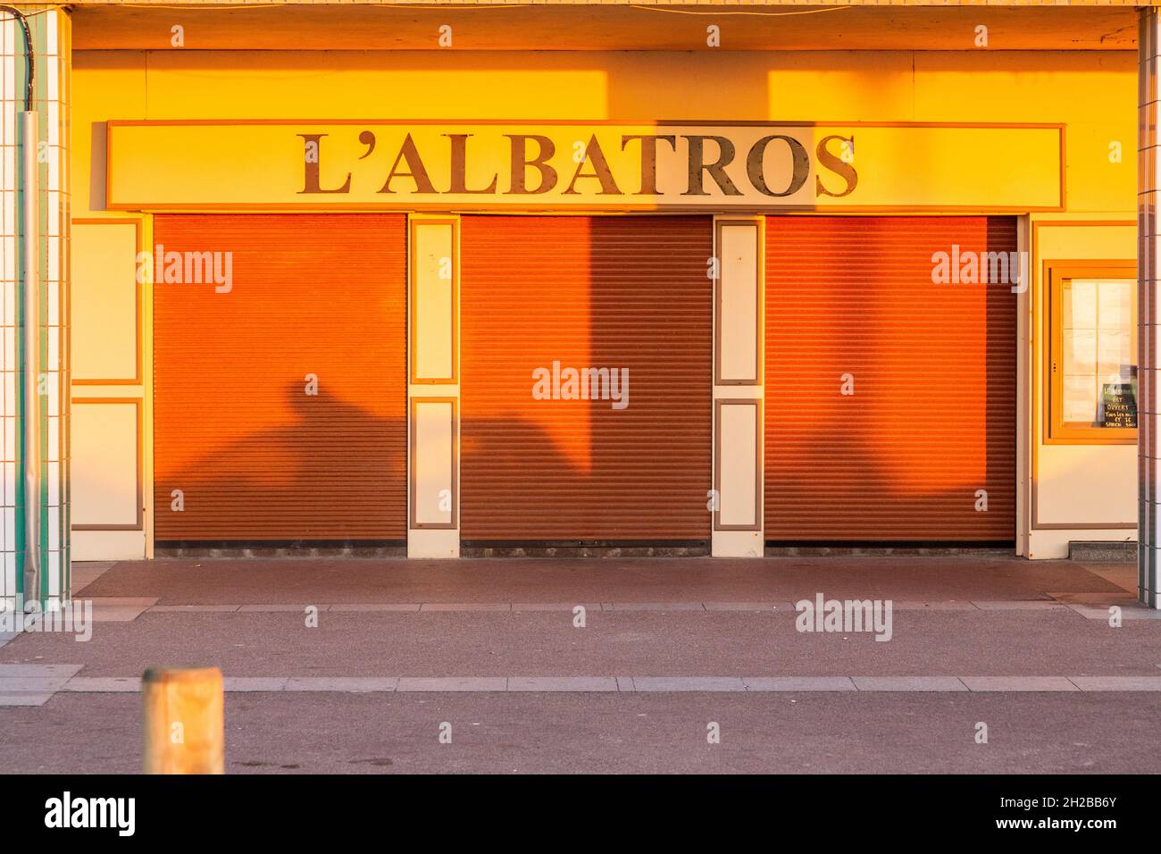 Establishment named 'L'Albatros', shutters closed, evening light, shadows. Berck-Plage, Côte d'OPale, FRance Stock Photo