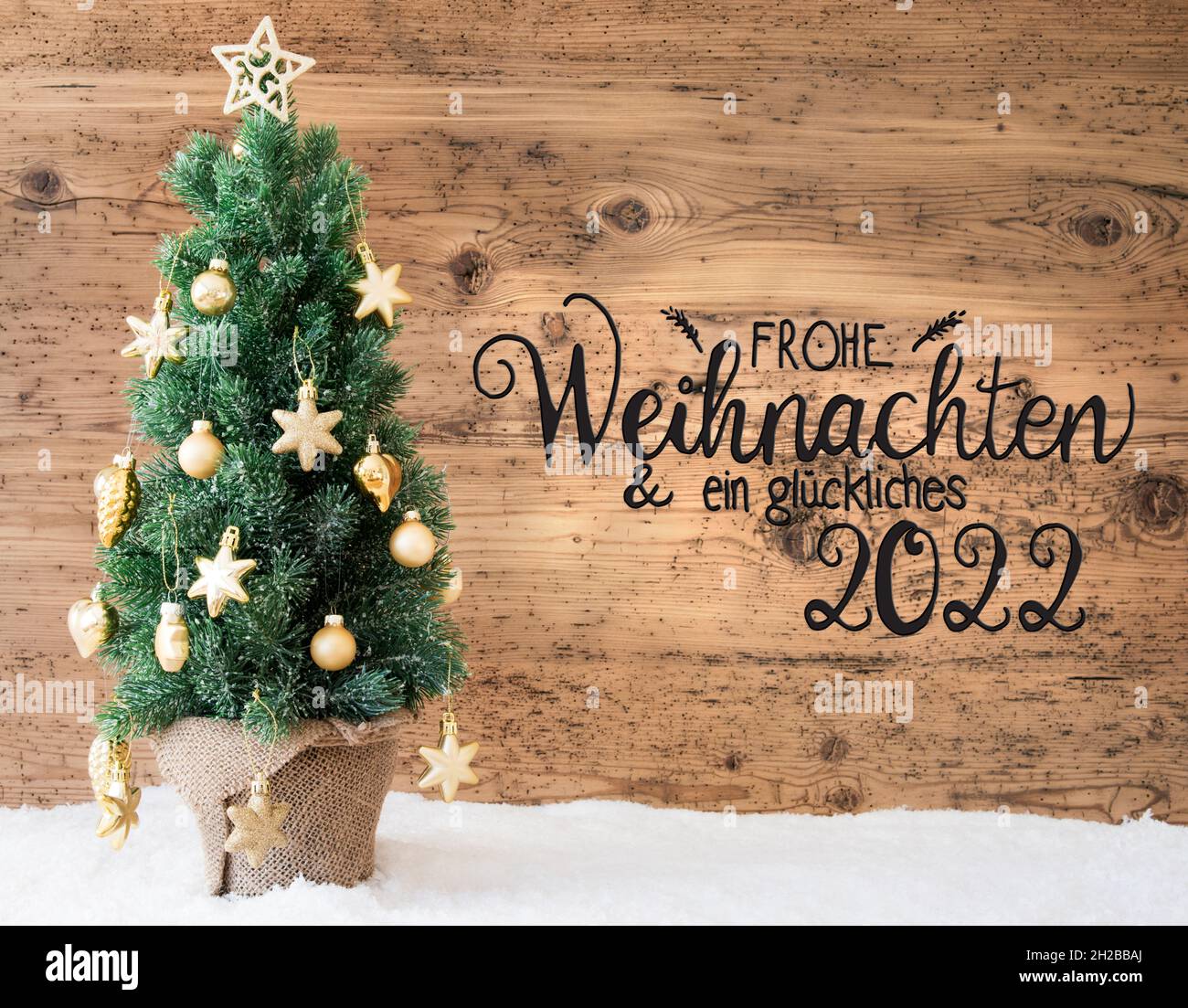 Christmas Tree, Wooden Background, Snow, Glueckliches 2022 Means Happy 2022 Stock Photo - Alamy