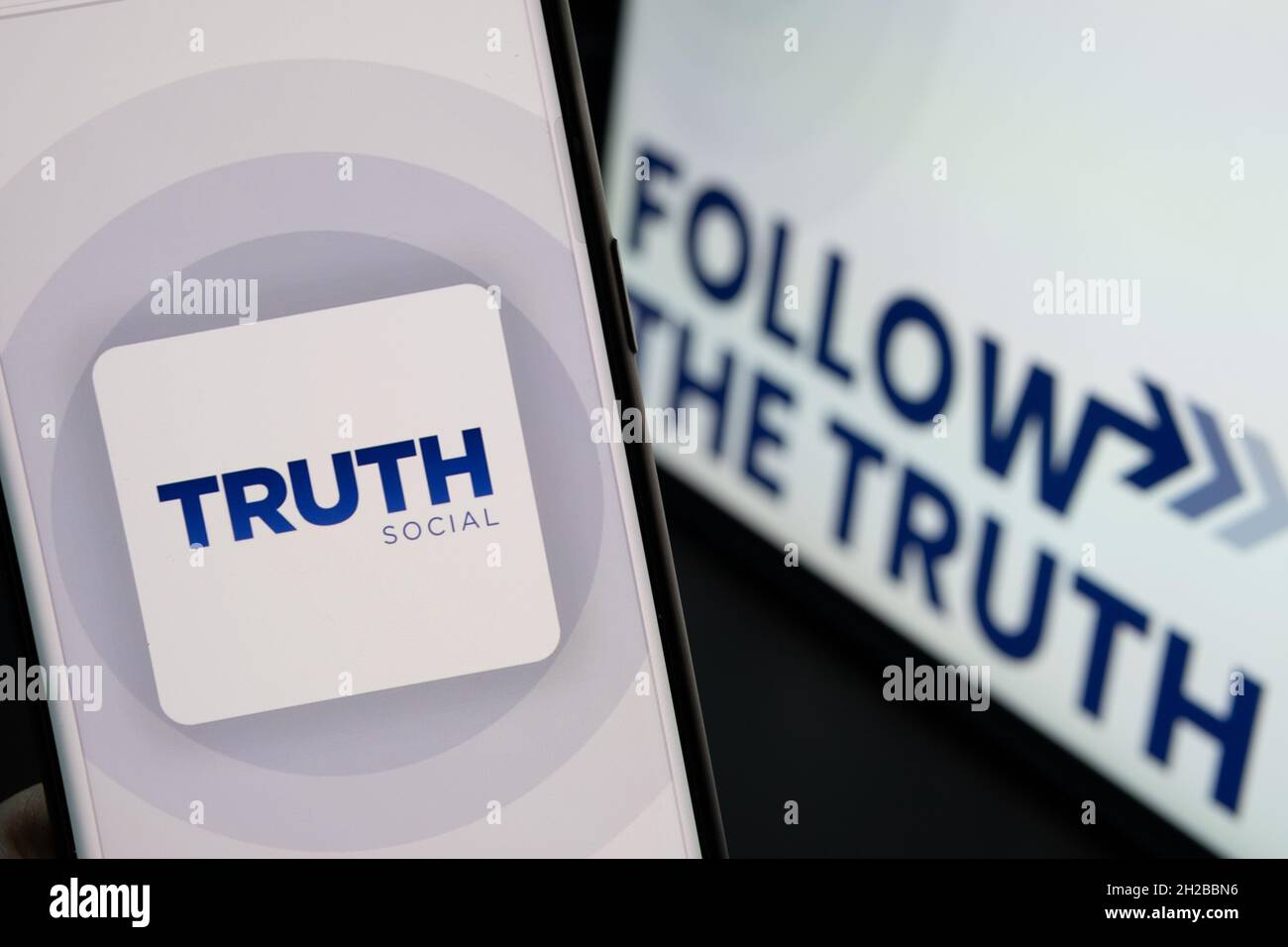 Truth Social app logo seen on the smartphone and the Follow the fruth(04)