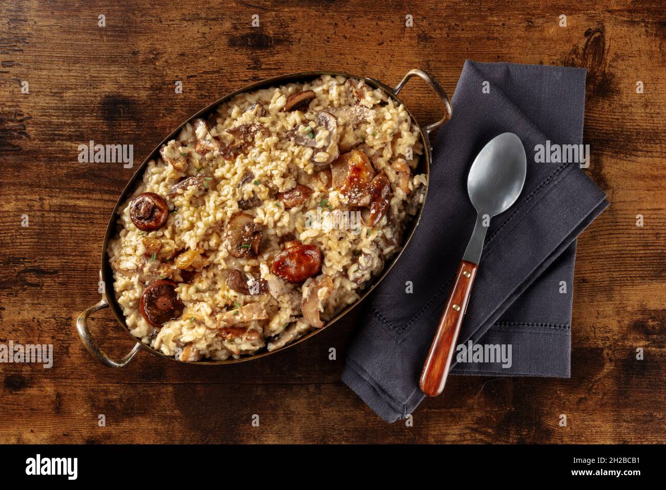Mushroom risotto, rustic rice with mushrooms, shot from the top on a dark wooden background Stock Photo