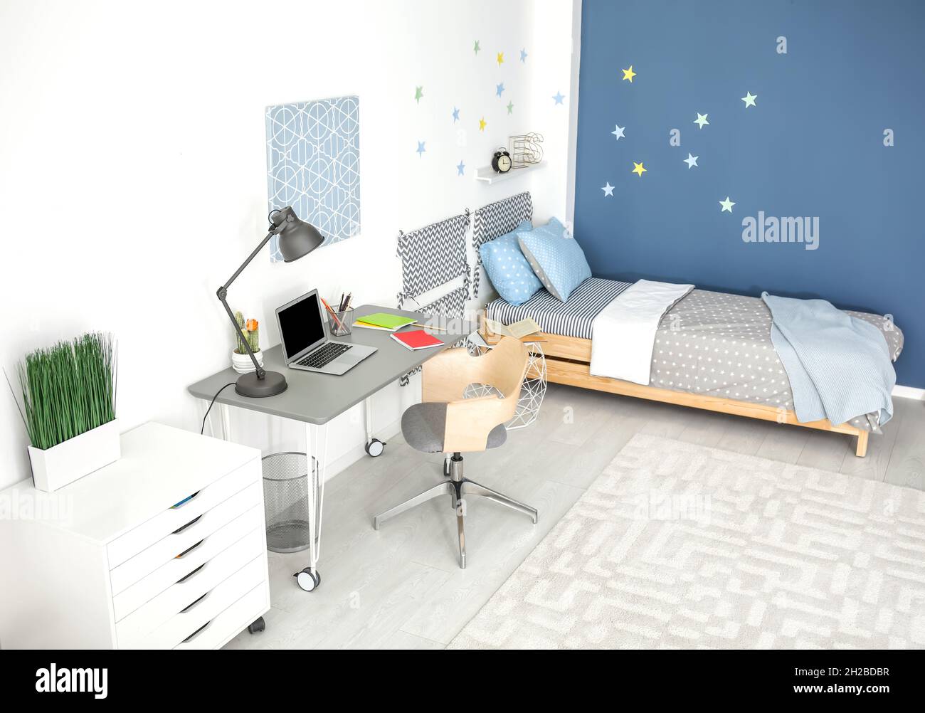 Modern child room interior with comfortable bed and desk Stock Photo