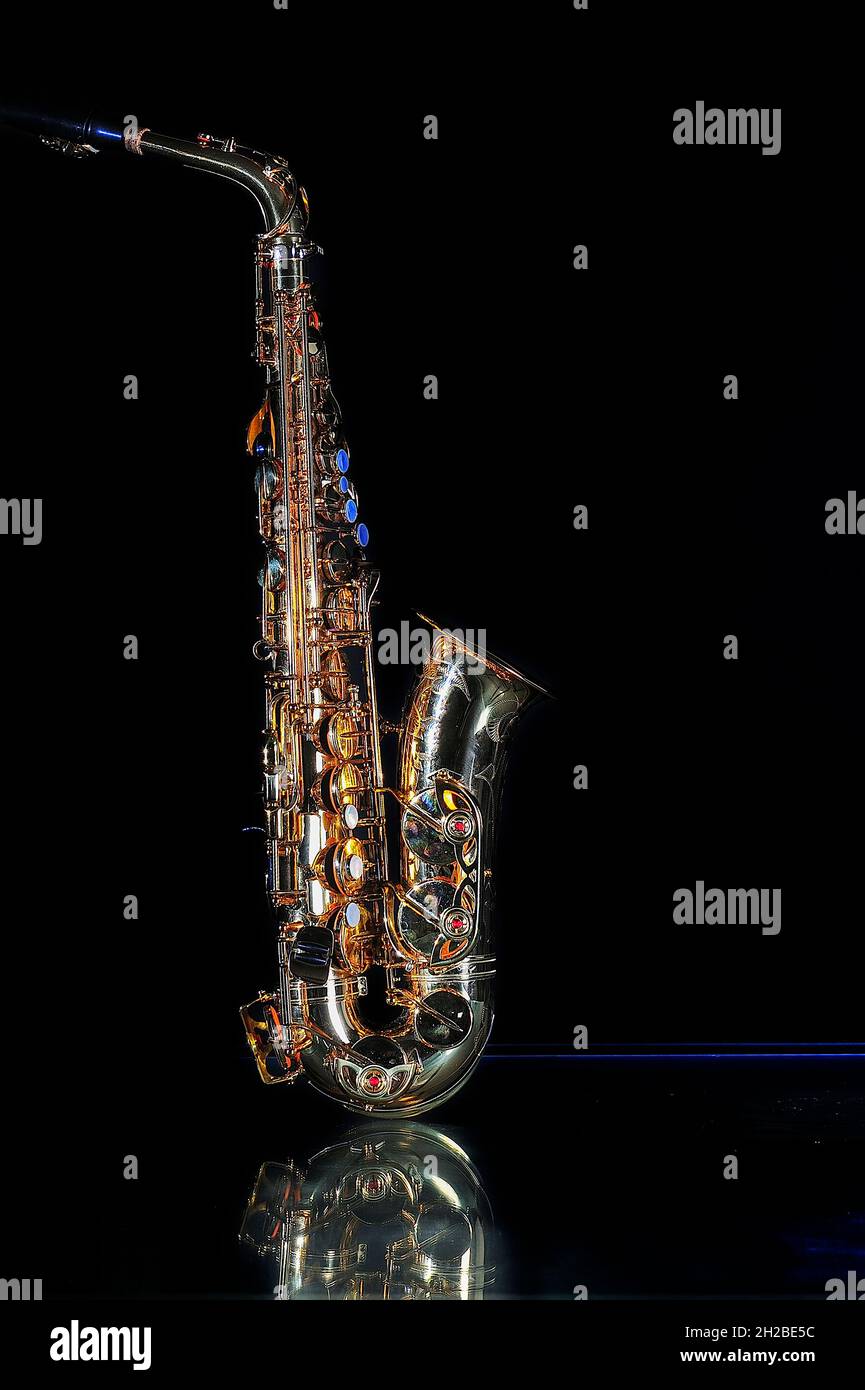 Saxophone isolated on black background. Dorado, stand up. Stock Photo