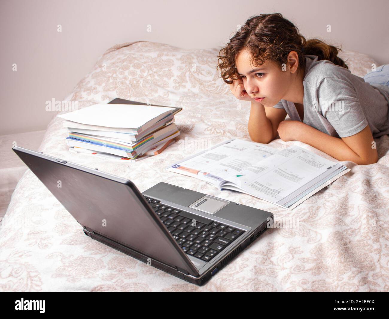 Teenager girl studying online at home. School girl with the lap top on