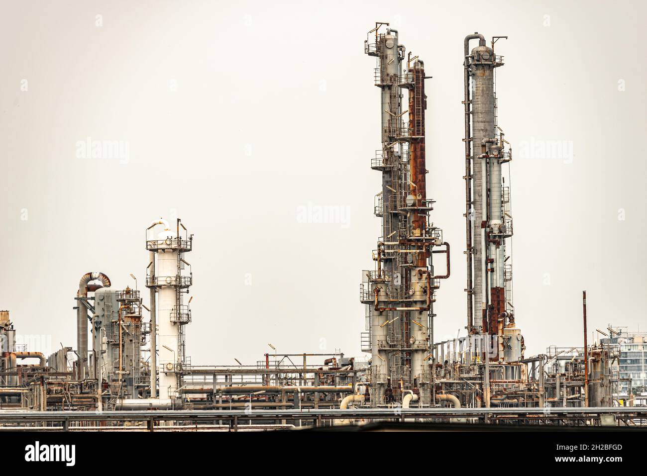 Refinery factory oil storage tank and pipeline steel on a over cast day Stock Photo