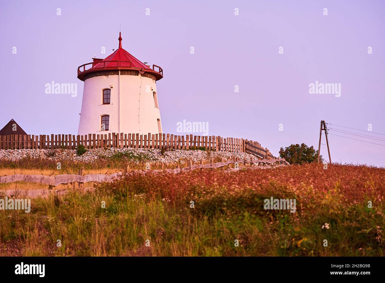 Historic German windmill against the background of a purple sky at dusk Stock Photo
