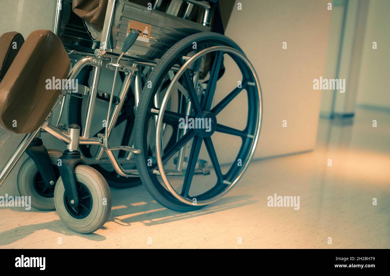 Empty wheelchair near hallway in hospital for service patient and people with disability. Medical equipment in hospital for assistance old people. Stock Photo