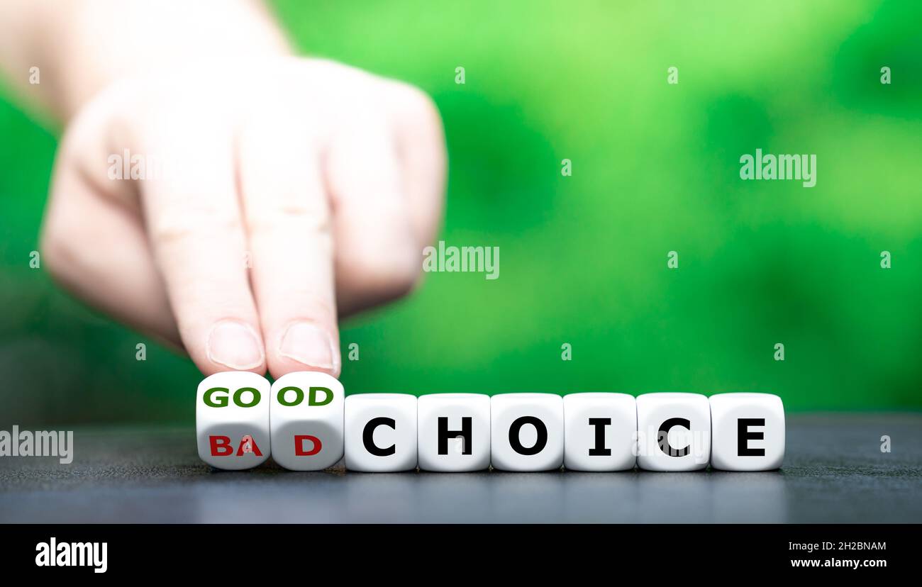 Hand turns dice and changes the expression 'bad choice' to 'good choice'. Stock Photo