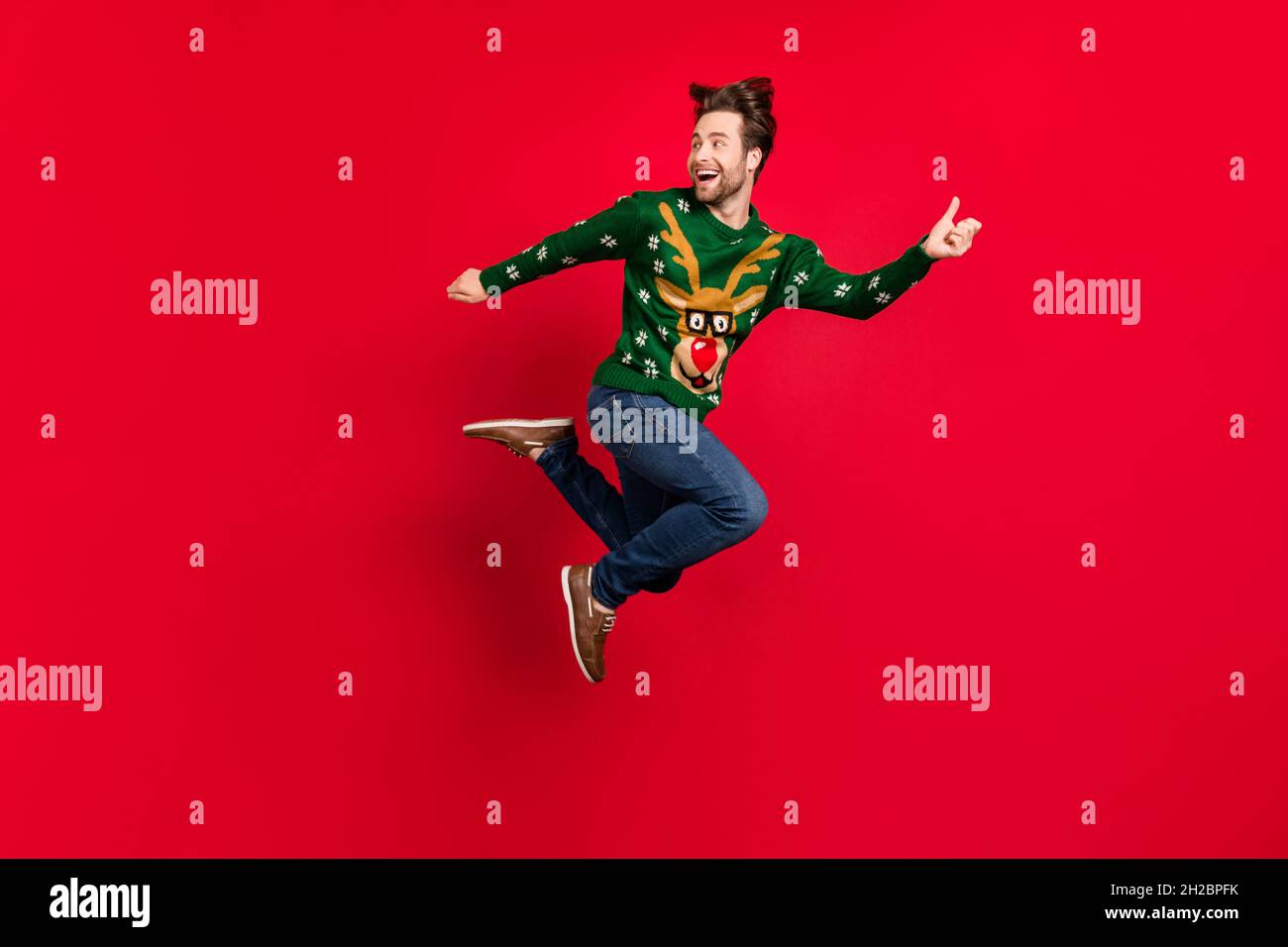 Full size profile side photo of smiling good mood male running fast speed playful escape isolated on red color background Stock Photo