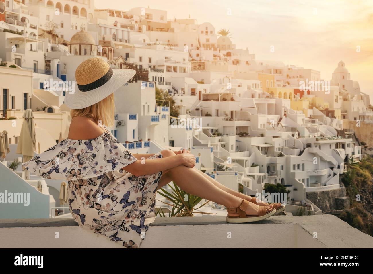 woman looking at sunset in Santorini island. Greek islands vacation Stock Photo