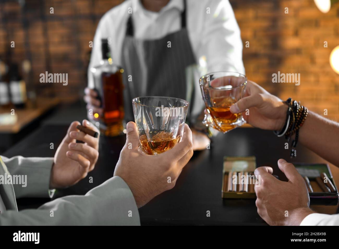 Friends drinking whiskey together in bar, closeup Stock Photo Alamy