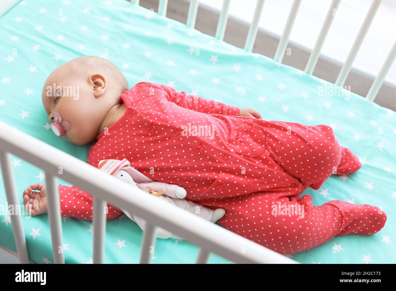 Cute baby girl sleeping in crib at home Stock Photo Alamy
