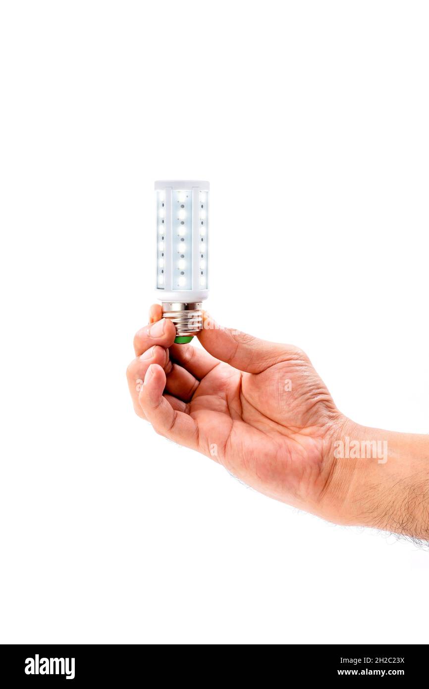 Human hand holding LED light bulb isolated on white background. Stock Photo