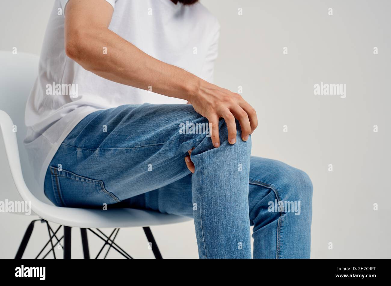 Man sitting on chair knee pain health problems Stock Photo Alamy