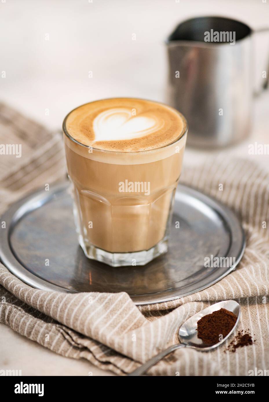 Flat white coffee with heart shaped foam milk on tray Stock Photo