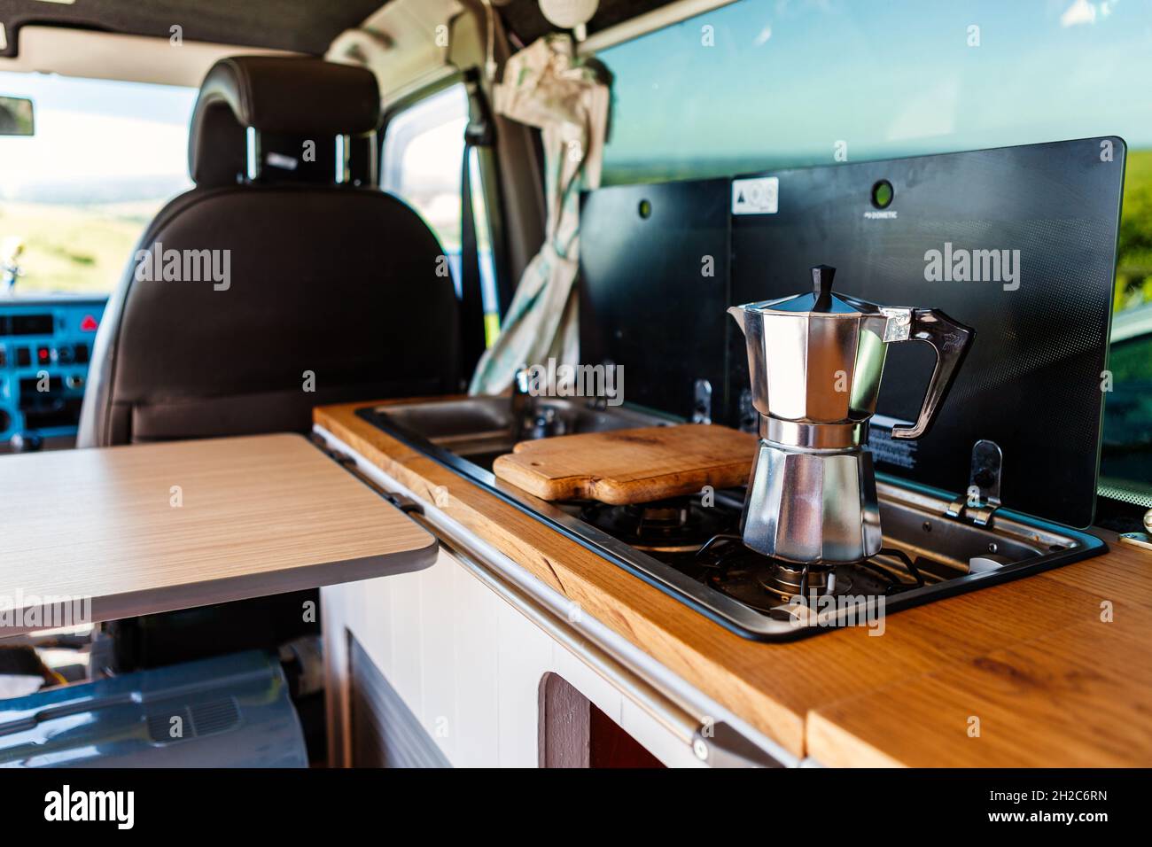 Aqua bialetti coffee maker on a camper van hob, in a T4 camper van Stock Photo
