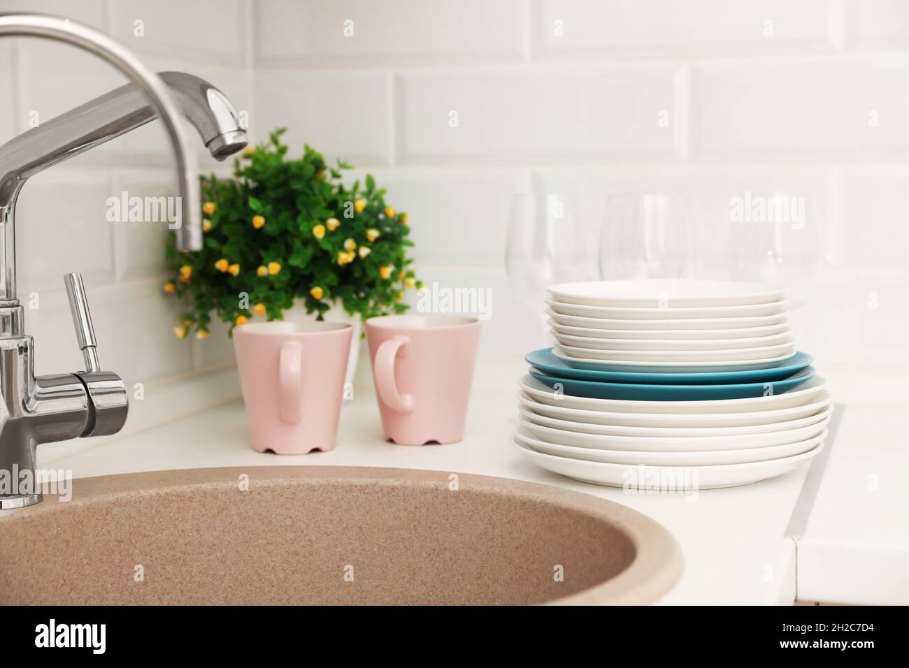 Clean dishes on counter near kitchen sink indoors Stock Photo Alamy